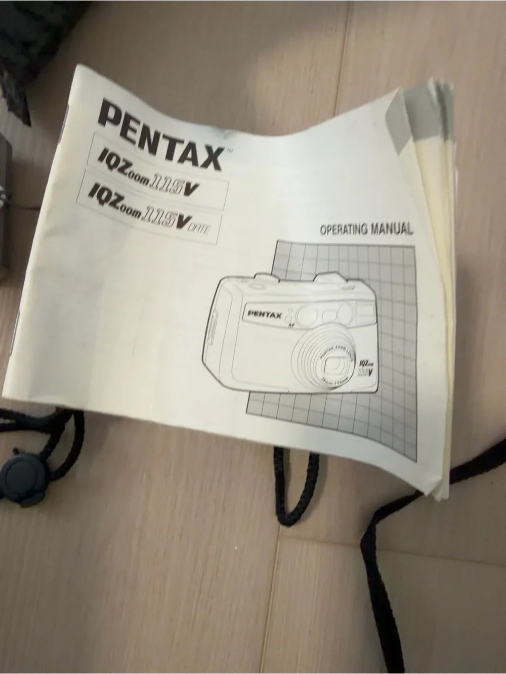 Pentax silver compact film camera with wrist strap